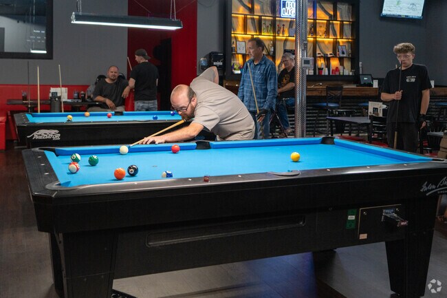 Friends enjoy a game of billiards at Stix on 36 near Decatur's Chevrolet Hall of Fame Museum.