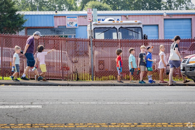 Summer camps with groups of kids explore the Rose Hill neighborhood.