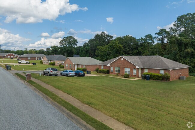 Houses with simply manicured lawns line the streets of Harmon Estates.