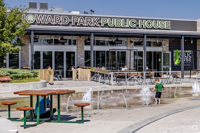 Kids can cool off at a splash pad fountain in front of Howard Park Public House.