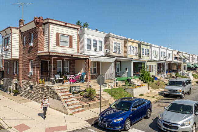 Rowhomes with front porches catch the morning sun as it rises over Lawncrest.