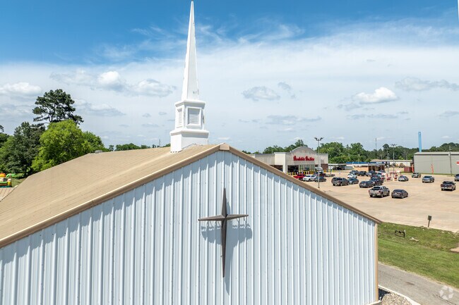 A church cross overlooks Brookshire Brothers, blending faith and daily life in Stanley.