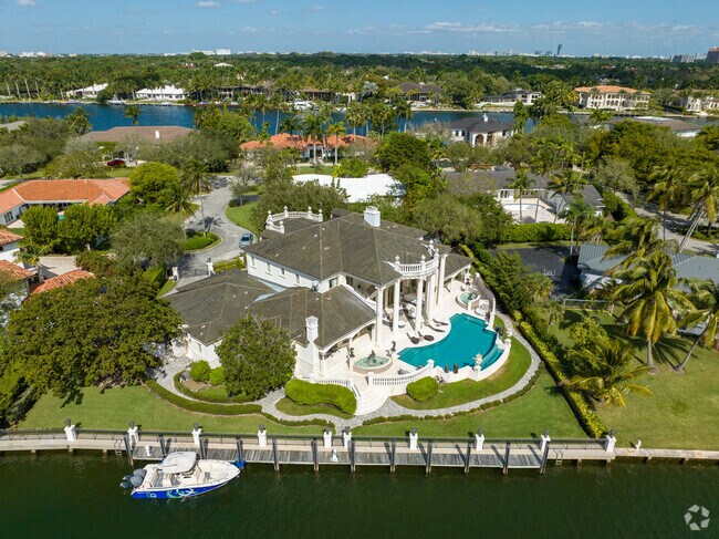 A large luxury home in Gables Estates sits by the water.