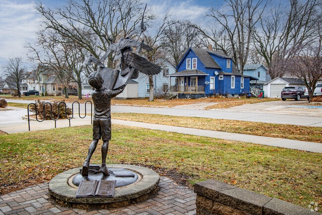 Bronze reading statue stands near the Clarion Public Library.
