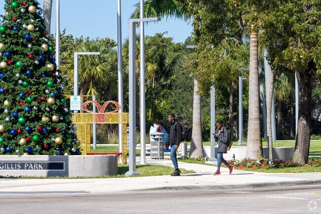 Locals walking on the 
sidewalk at Christmas time.