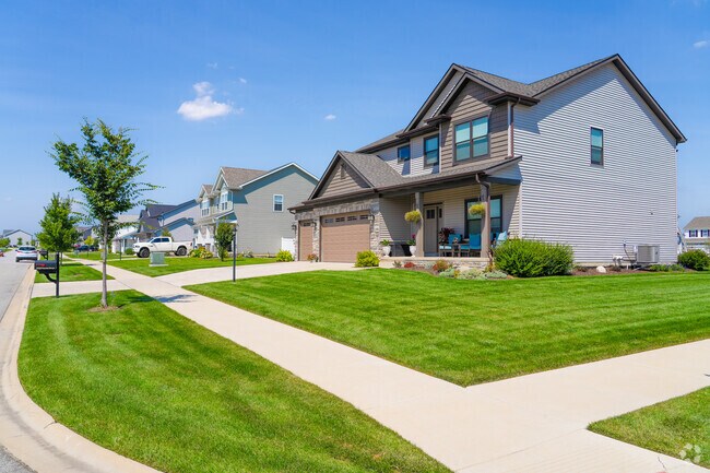 Residents enjoy neatly landscaped lawns on clean streets in Winfield, Indiana.