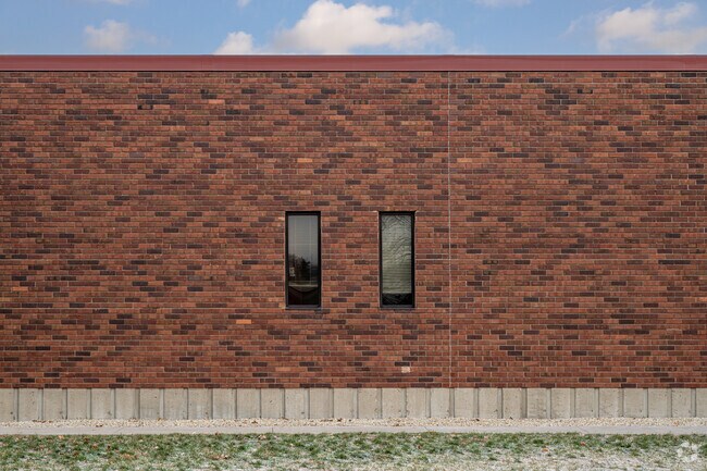 Community School of Excellence has a repetitive architectural design with narrow windows.