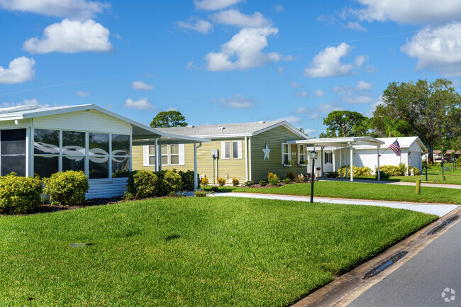 In Edgewater Landing, a row of well-maintained manufactured homes boasts pristine landscapng.