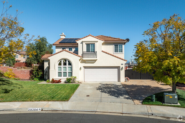 A gorgeous Spanish-style home with a large arched window is seen in Winchester-Silverhawk.