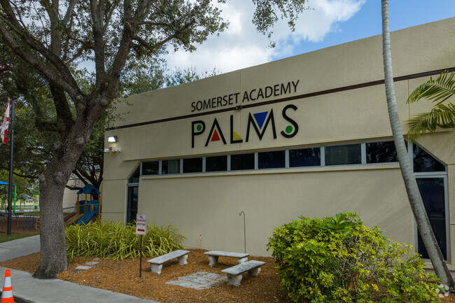 The Somerset Academy Palms sign on the side of the school building.