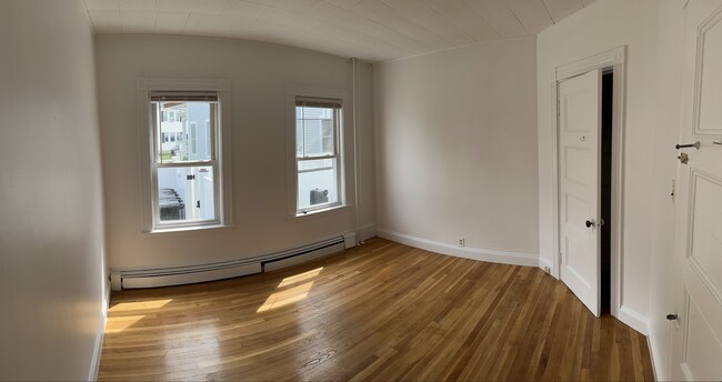 Sunlit back bedroom (3rd) with charming corner closet. Queen/full.