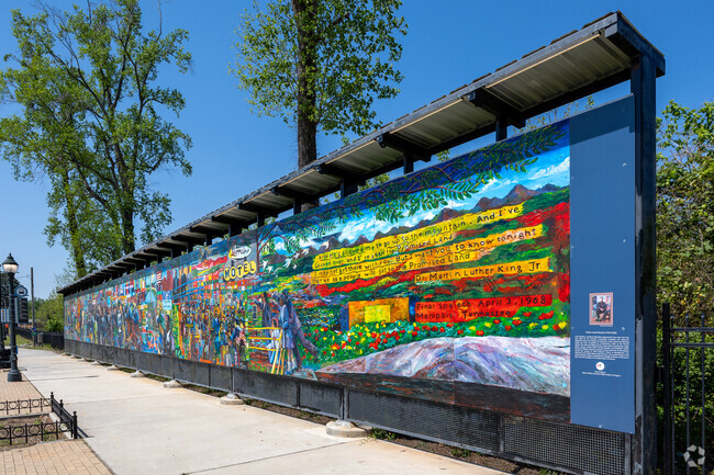 A large mural in Fairburn Mays showing civil rights movement by the artist Louis Delsarte.