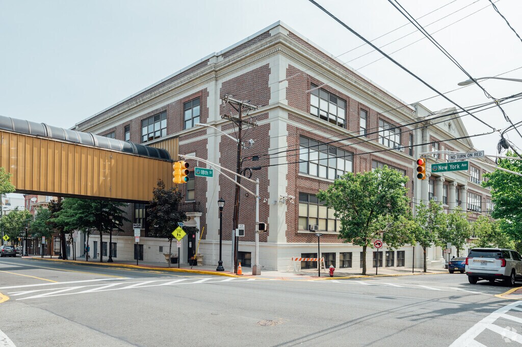 Emerson Middle School sits in Union City on a busy road with a bridge going across both sides.
