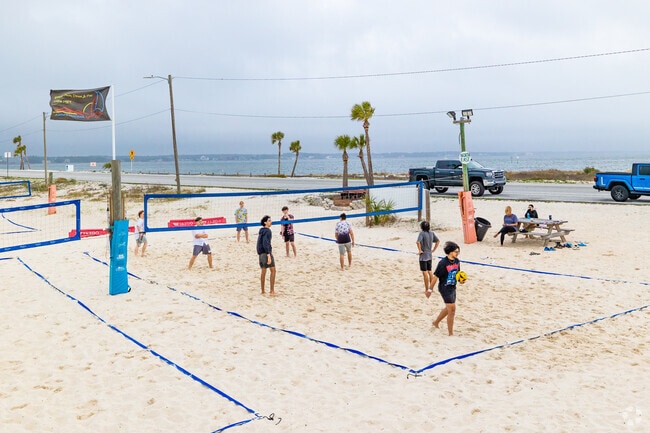Friends enjoy a volleyball game in Navarre Beach, FL.