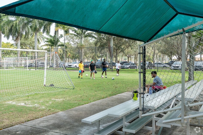Locals resting after playing soccer at Plantation Acres North Park.
