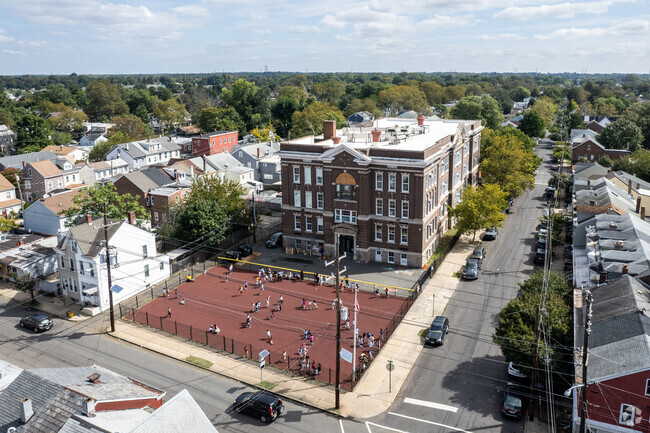 Franklin Elementary School has a school yard in the front of the building for the kids to play.