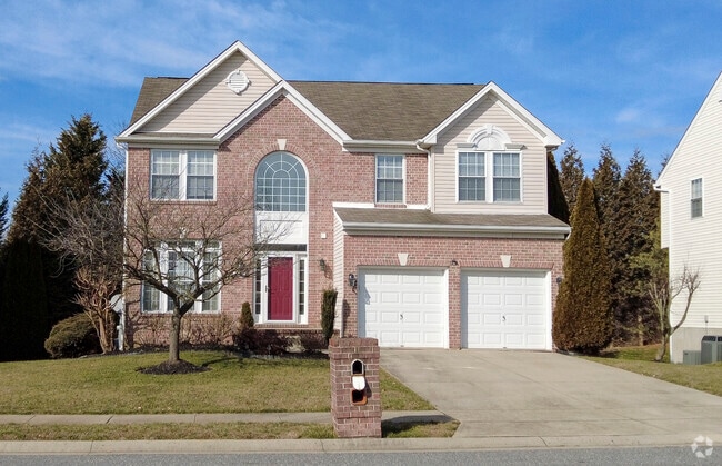 This large single-family home offers a large driveway and two-car garage.
