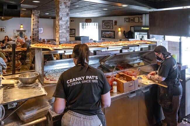 Fresh pizzas are being prepared at Cranky Pat's Pizzeria, just east of Astor East River.