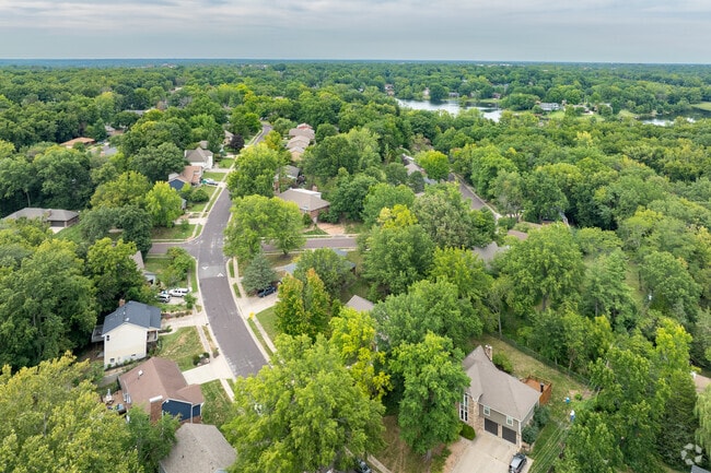 The streets of Southwest Hills wind their way through dense trees revealing many unique homes.