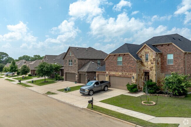 Some Paloma Creek South homes feature mixed stone and brick exteriors.