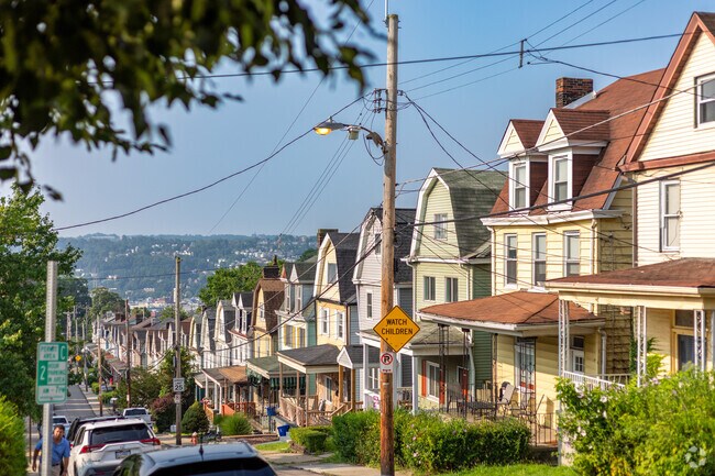 A look down a street of homes in West Oakland on a sunny morning.
