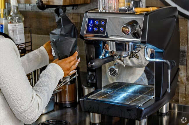 A friendly barista makes a cappuccino at Downtown Hampton's Guilty Pleasures Coffee Shop.