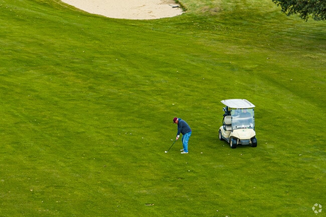 Golfers enjoy rolling fairways and open skies at Pine Island Golf Course.