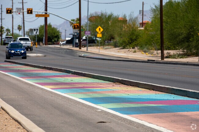 12th Avenue has rows of colorful, rainbow painted bike paths in Sunnyside that are cheerful.