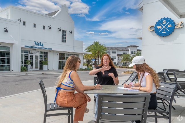 Sun Bay South neighbors lounge outdoors for a quick meeting.