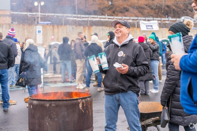 Friends enjoy drinks and warm up by the fire at Schuylkill Winterfest in Pottsville.
