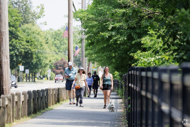 People enjoying the shaded pathway around Horseshoe Lake in Succasunna, NJ.