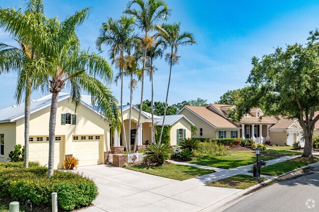 Homes in Osprey feature tall palms and historic live southern oaks.