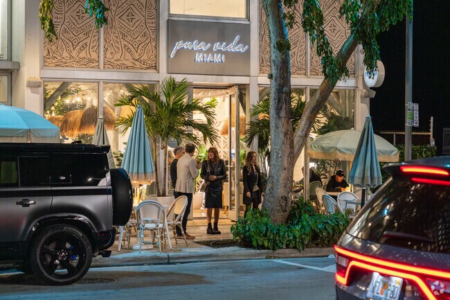 Residents wait outside of a Design District restaurant for their ride.