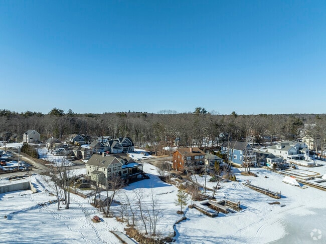 An aerial perspective of Arlington Pond's lakeside homes, nestled among peaceful surroundings.