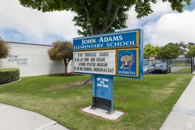 John Adams Elementary School sing selcomes students to the school.