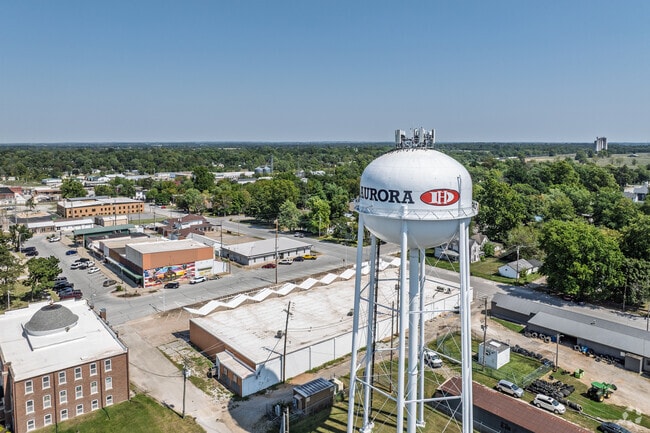 Aurora water tower marks the skyline above neighborhoods and shops.