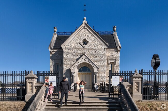 Families enjoy a stroll around the Crescent Hill Gatehouse and Reservoir near Rolling Fields.