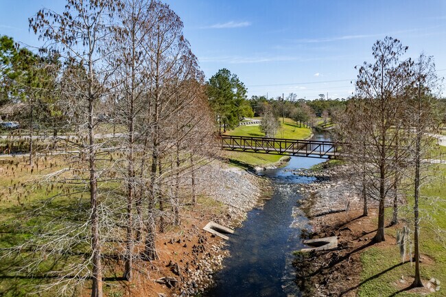 A bridge goes across the river of  Riverside Acres Park.