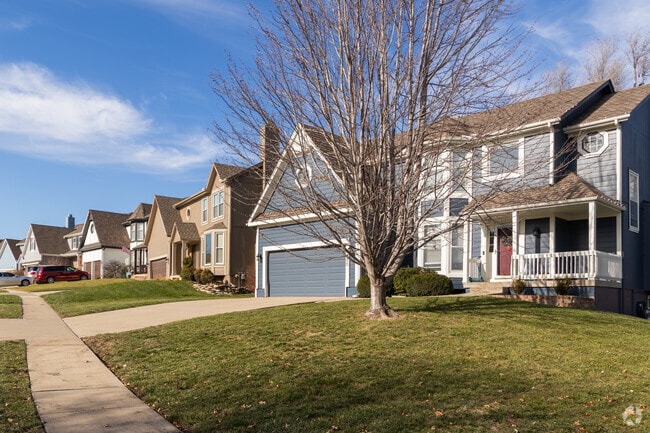 Pinehurst homes often include front porches and paved driveways.