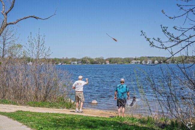Residents play fetch with their dogs at Gray's Bay in Minnetonka.