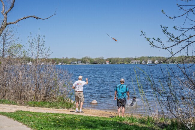 Residents play catch with their dogs at Gray's Bay in Minnetonka.