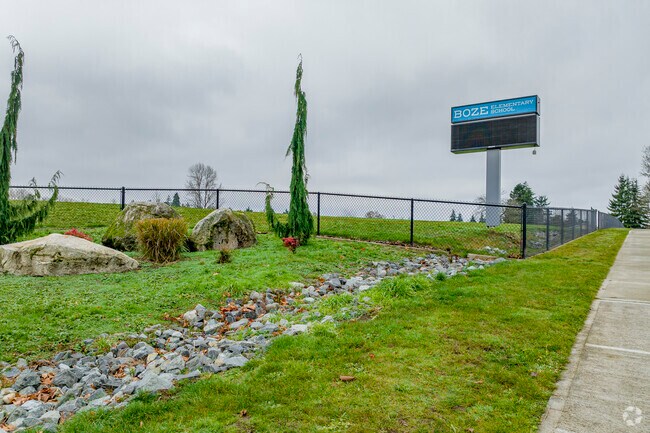 Dry creek running towards sign for Boze Elementary School.