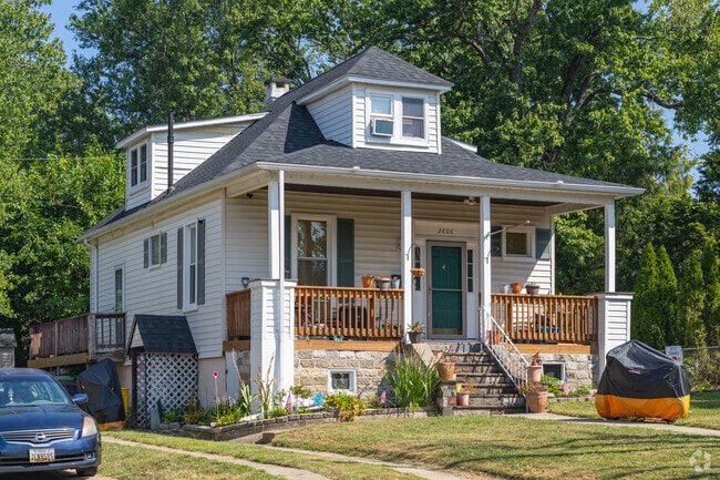 A cozy bungalow-style home in Christopher has a wide front porch and dormer window.