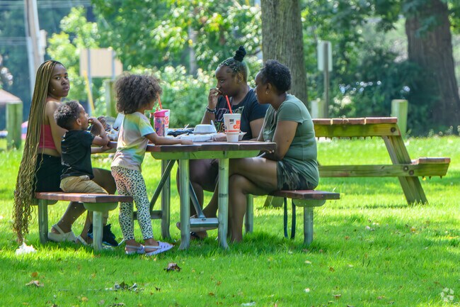 A family has a peaceful lunch in Milham Park near Westnedge Hill.