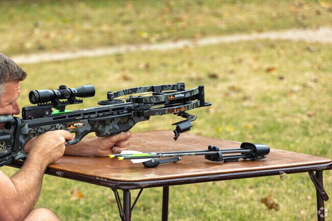 This man practices with his cross-bow for a weekend hunting trip in Buder North archery range.