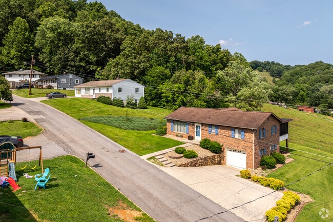 Brick and siding clad homes sit on a ridge in Morrison City.
