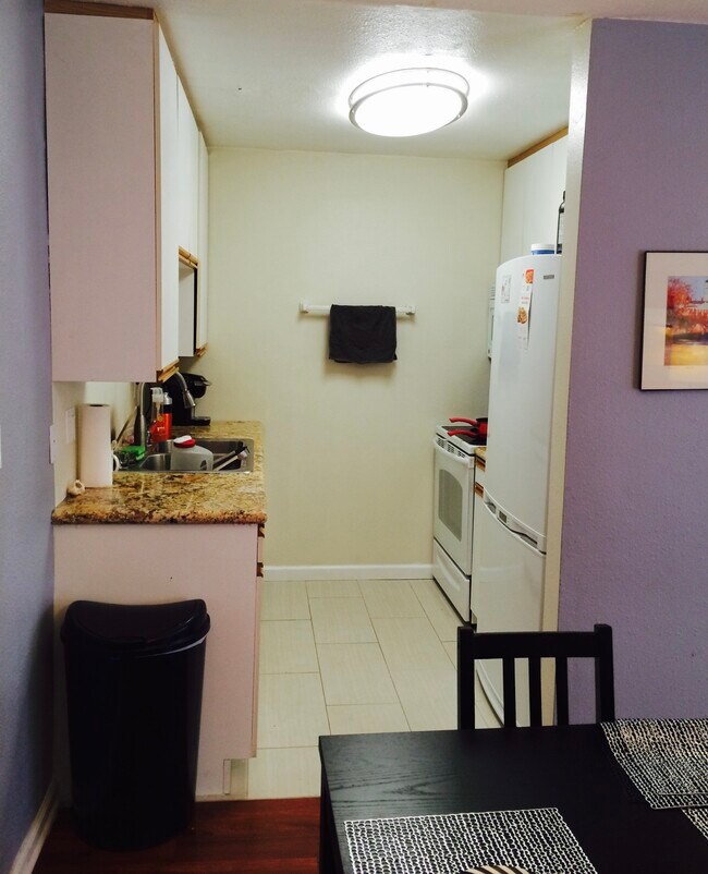 Marvel countertops in the kitchen sit on all new White appliances including a dishwasher