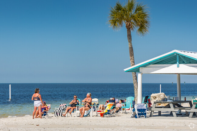 Flor-A-Mar residents bask in the sun at the neighborhood private beach club.