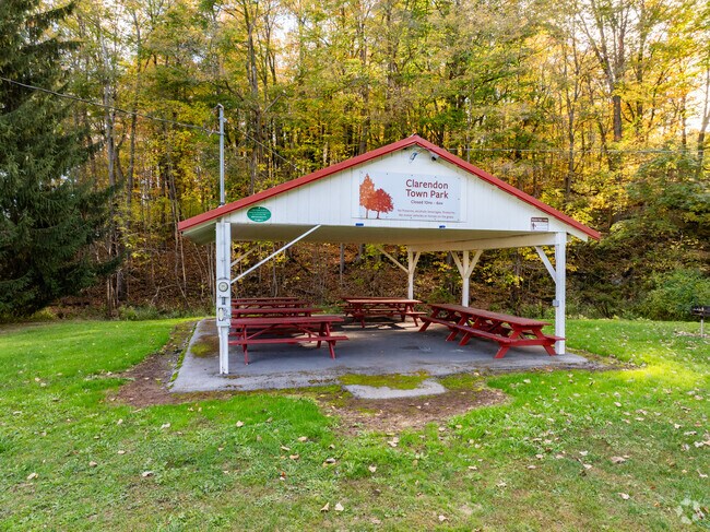 Clarendon Town Park features a covered pavilion and picnic area surrounded by woods, perfect for small gatherings.