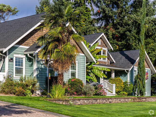 Beautiful estate home are framed by lush palm trees in Lake Burien.